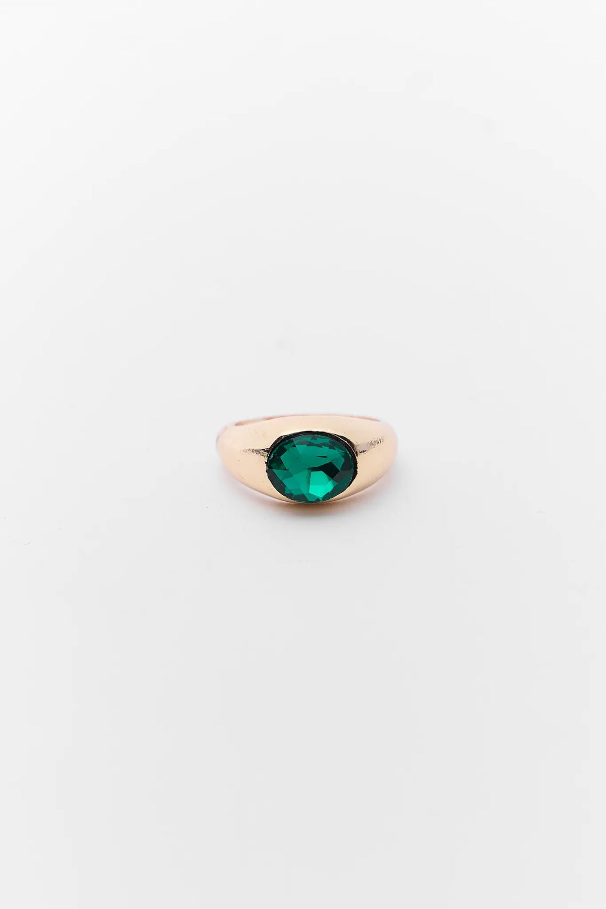 Gold earring with a green gemstone on a white background