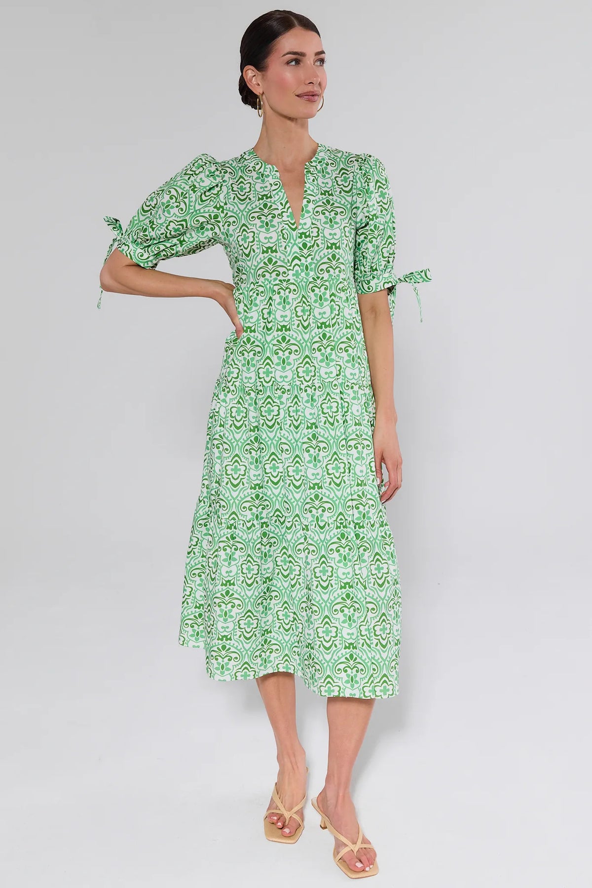 Woman wearing green abstract print puff sleeve midi dress with tie sleeves - Front View | Avara