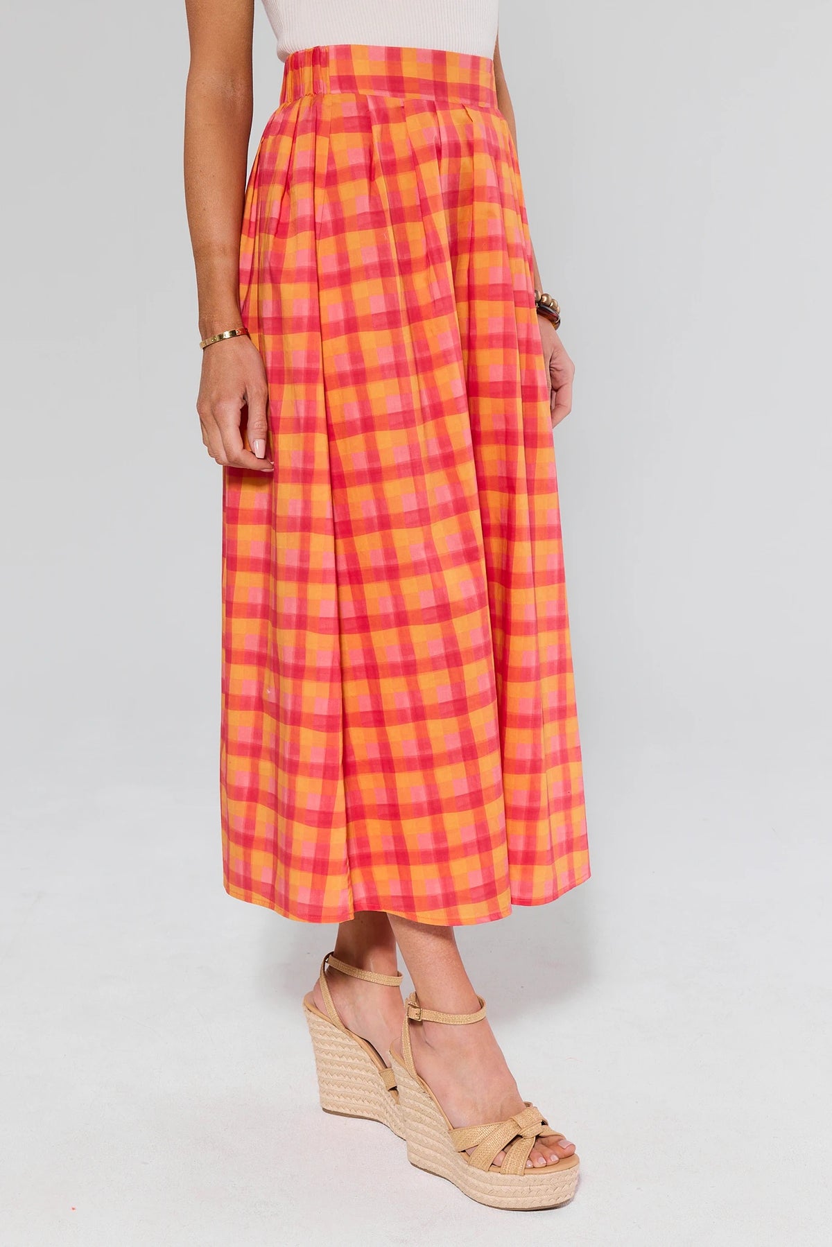 Estie Orange Plaid Midi Skirt - Side View showing pleated A-line silhouette | Avara
