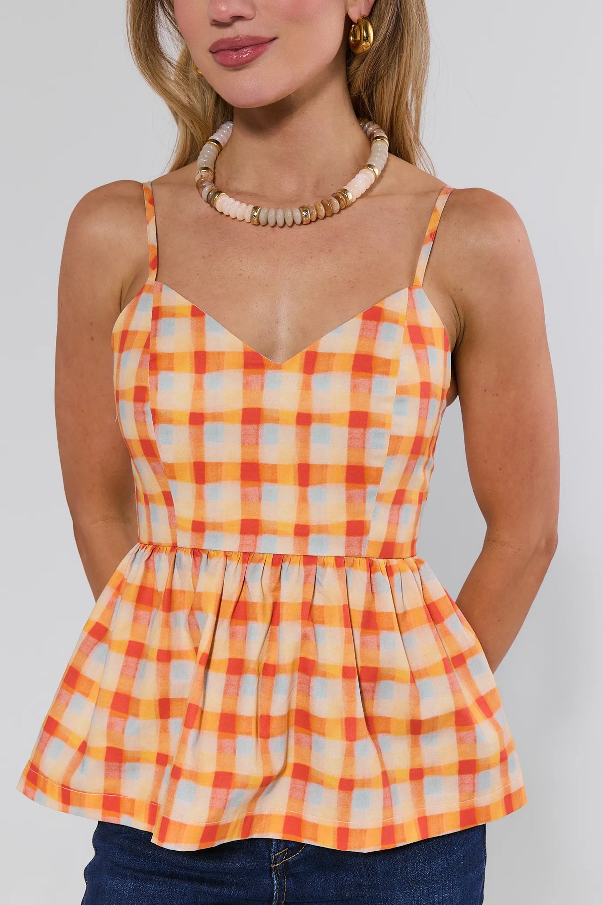 Lynlee Orange Plaid Peplum Top - close-up front detail, V-neckline and gathered waist | Avara