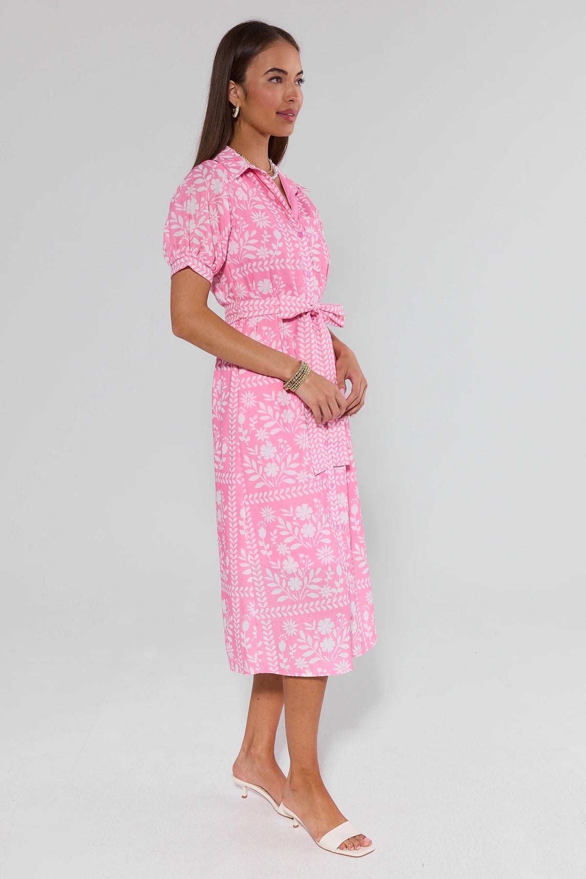Pink white floral Magnolia modest midi dress side profile view showing knee-length hem and tie belt | Avara