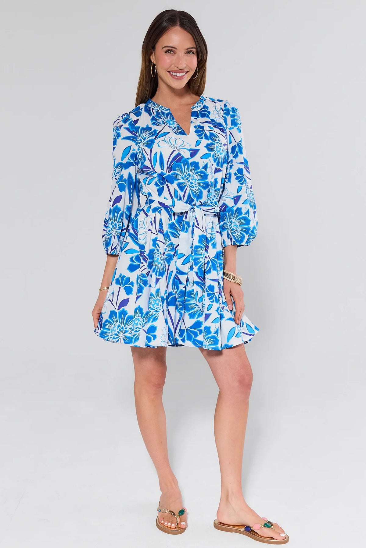 Woman in blue floral mini dress with A-line skirt and sandals - Full Length Front View | Avara