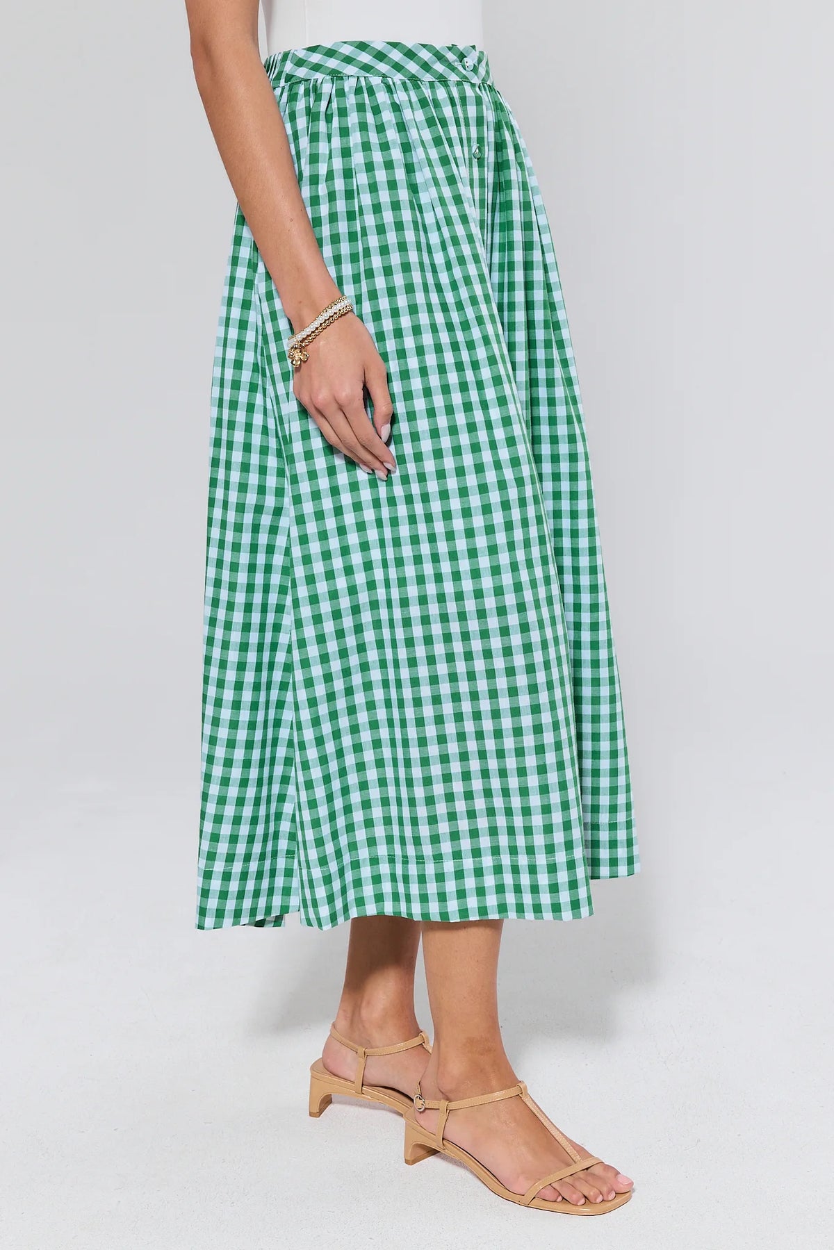 Green gingham midi skirt showing flowy A-line silhouette and elastic waist - Side View | Avara