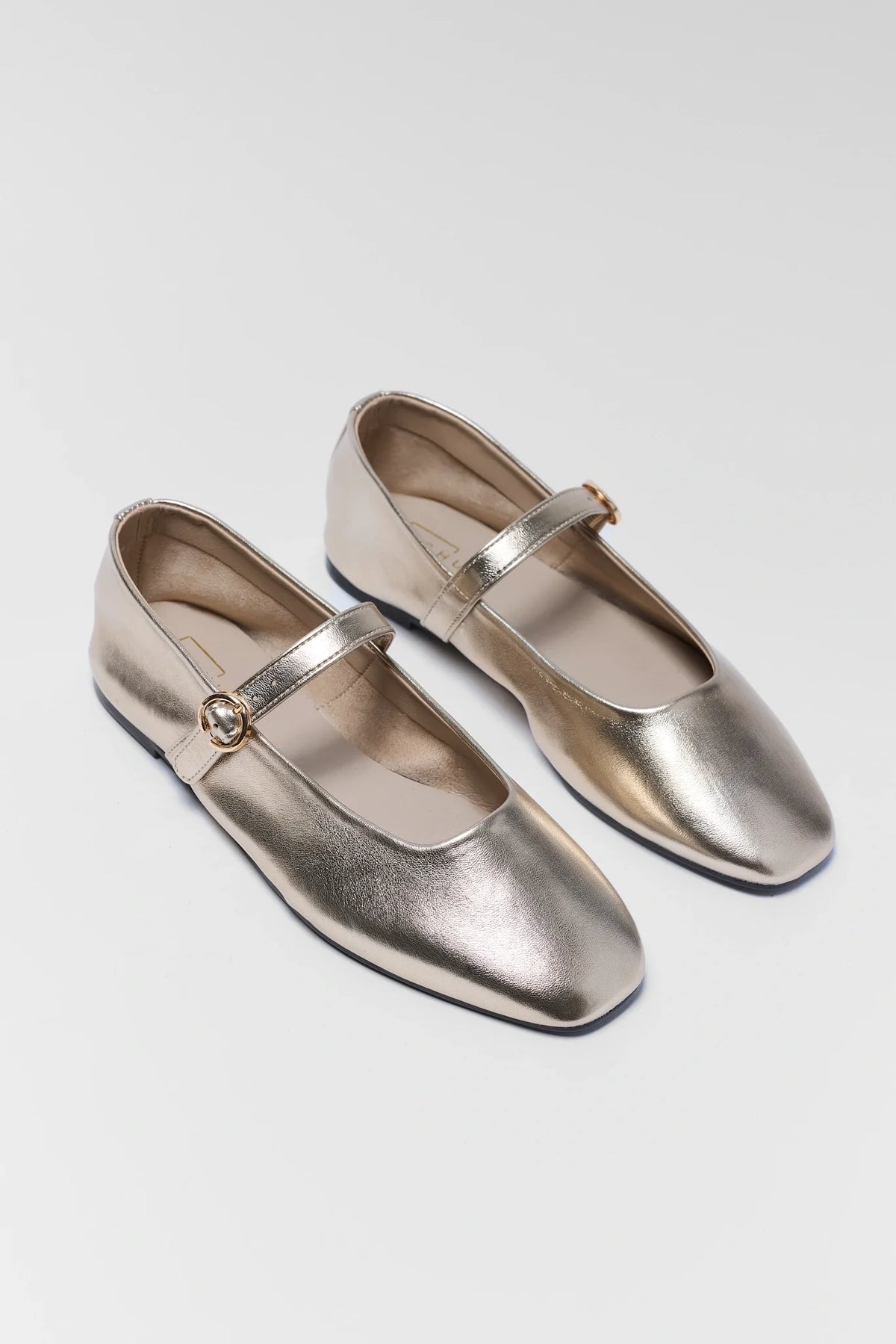 Gold metallic ballet flats with adjustable strap and square toe - Angled Pair View | Avara