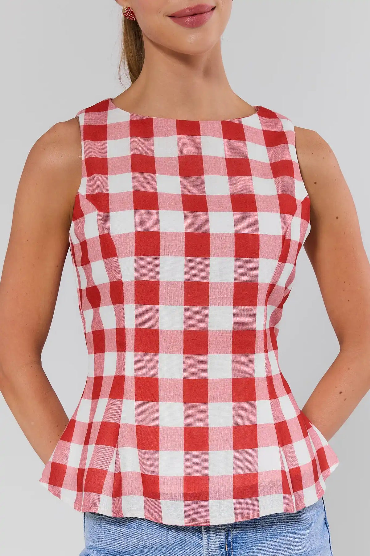 Close-up of red gingham peplum top with tailored waist and oversized check print | Avara