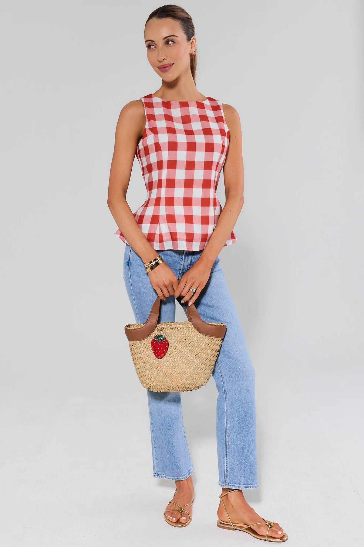 Women's red gingham top styled with blue jeans and a strawberry straw bag, full look | Avara