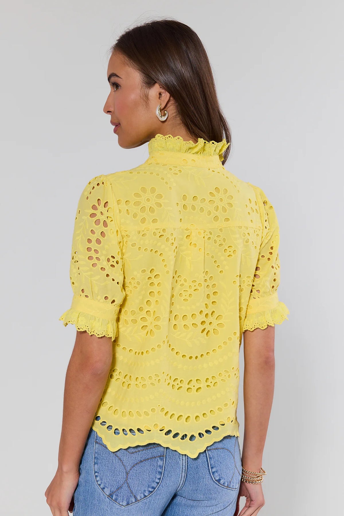Yellow eyelet button-up top showing ruffle collar and scalloped hem - Back View | Avara