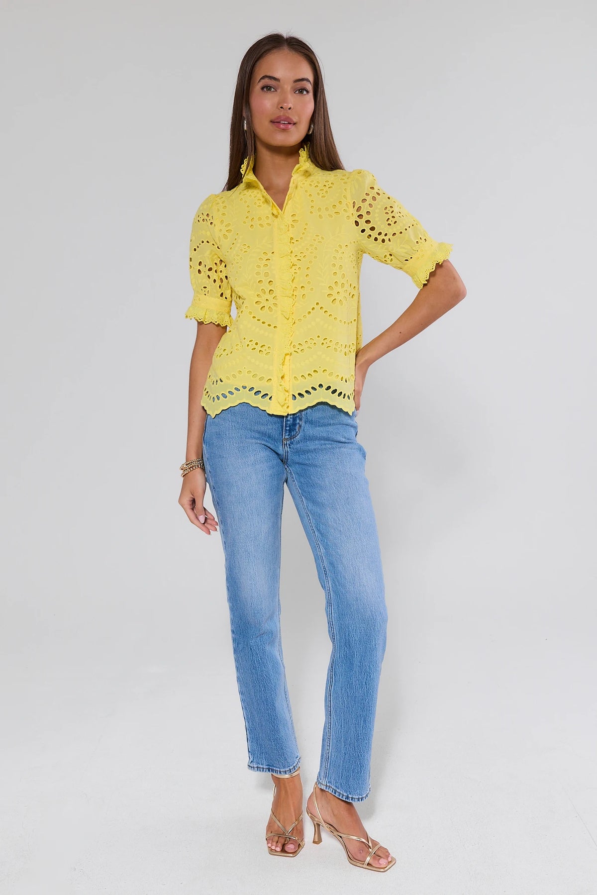 Yellow eyelet blouse styled with blue jeans and gold heels - Full Length Front View | Avara