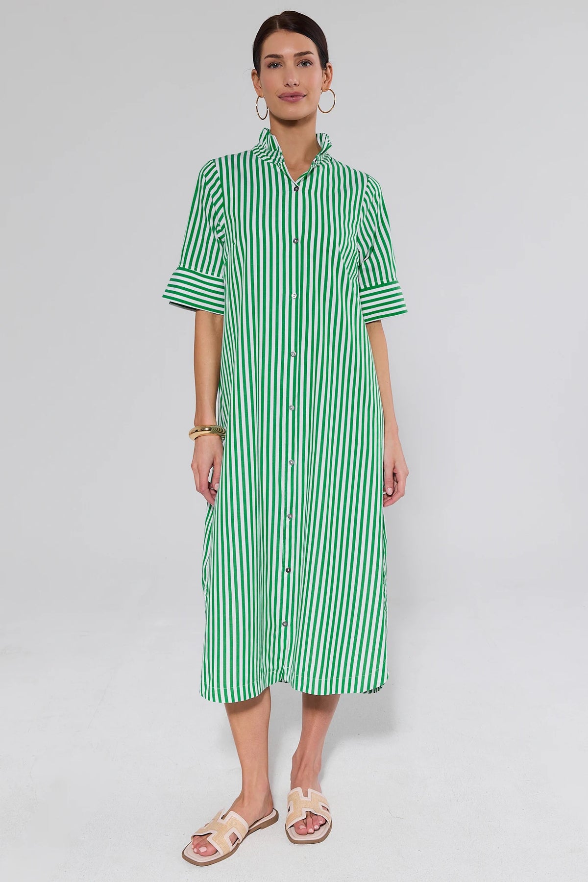 Woman in green striped midi dress styled with slide sandals, full-length front view | Avara