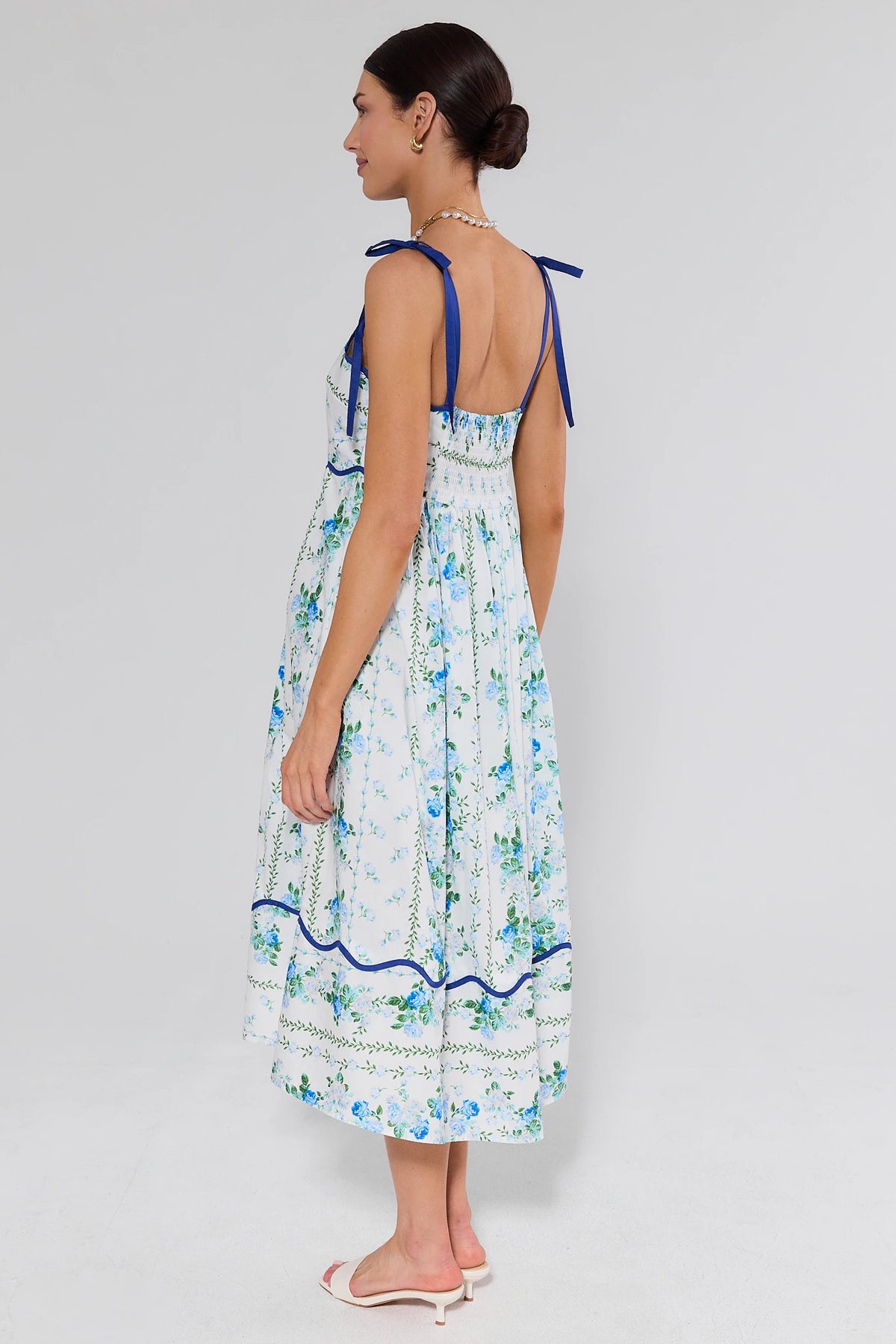 Flora Blue Floral Print Midi Dress back view showing open back, smocked waist, and scalloped trim | Avara