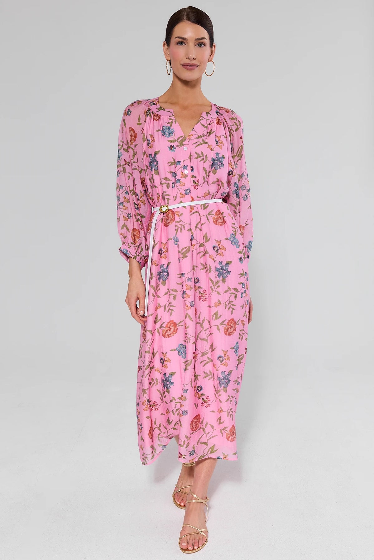 Pink floral maxi dress belted at waist, front view on model with gold sandals | Avara
