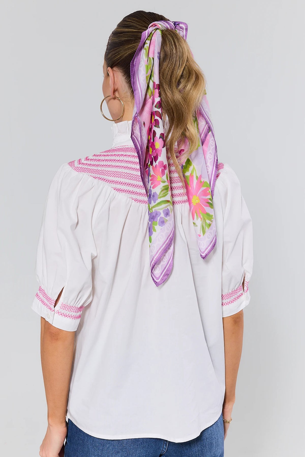 Back view of Yvonne White Pink Embroidered Top with gathered back yoke and pink embroidery detail | Avara