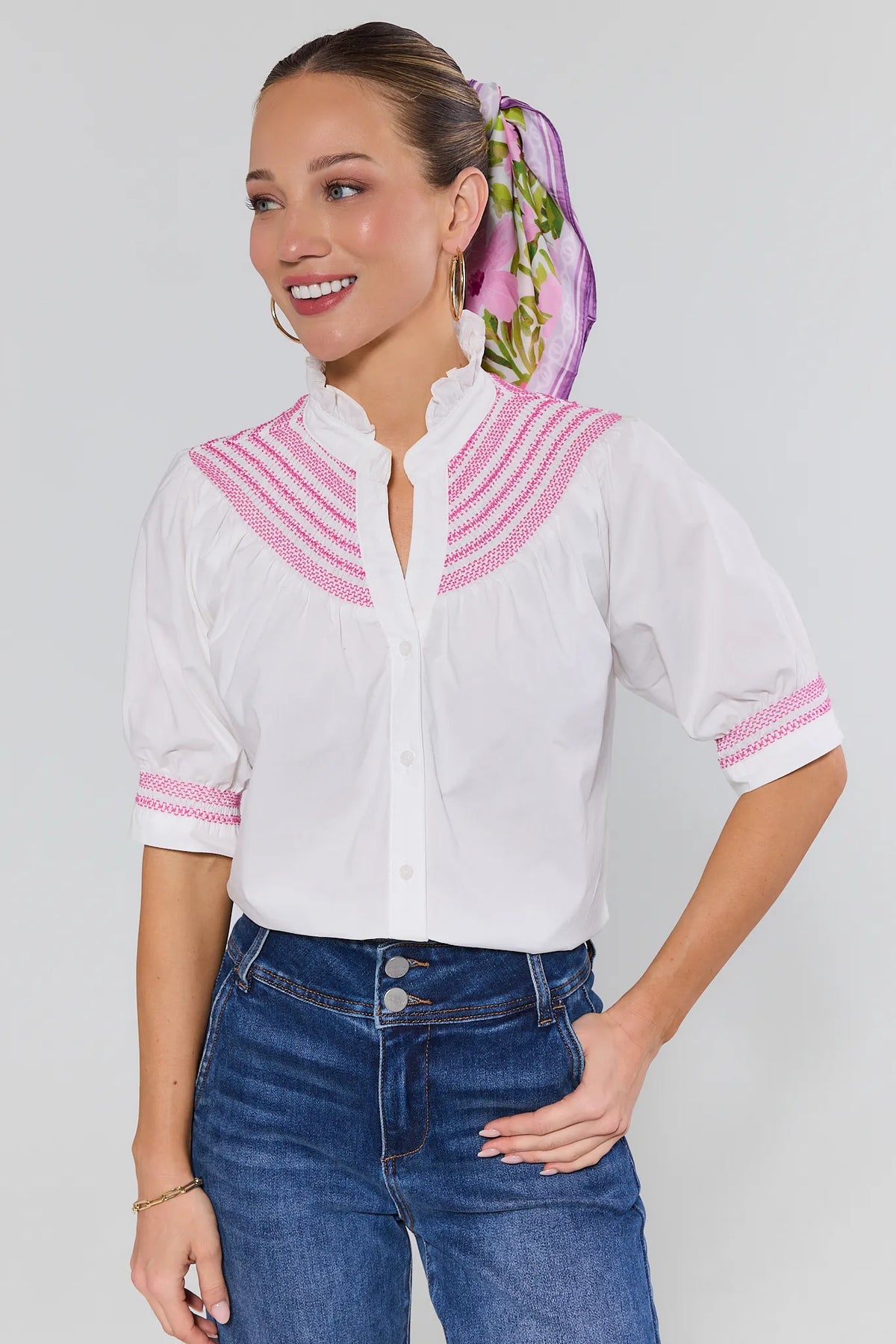 Yvonne White Pink Embroidered Top with ruffle collar and puff sleeves, styled with blue jeans - Front View | Avara