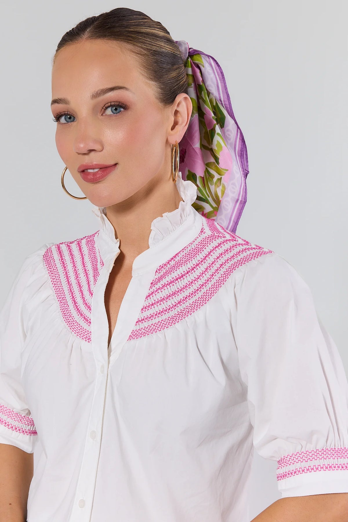 Close-up of pink embroidered yoke and ruffle neckline on Yvonne White Embroidered Top - Detail View | Avara