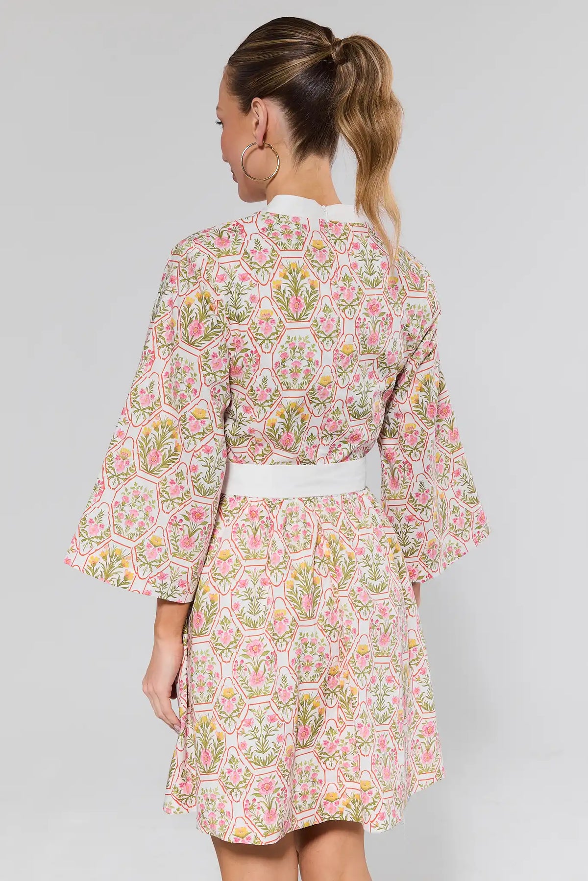 Cameron Multi Floral Short Dress back view showing bell sleeves, white waist belt, floral print | Avara