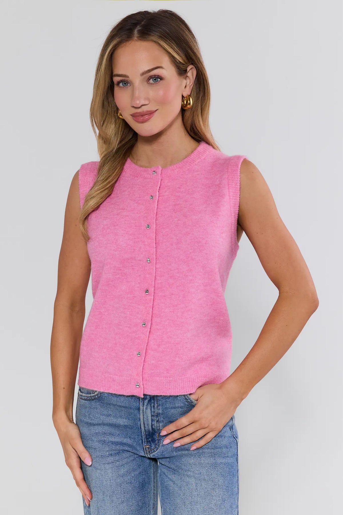 Pink knit button up sweater vest on model, front view with jeans - Martha | Avara