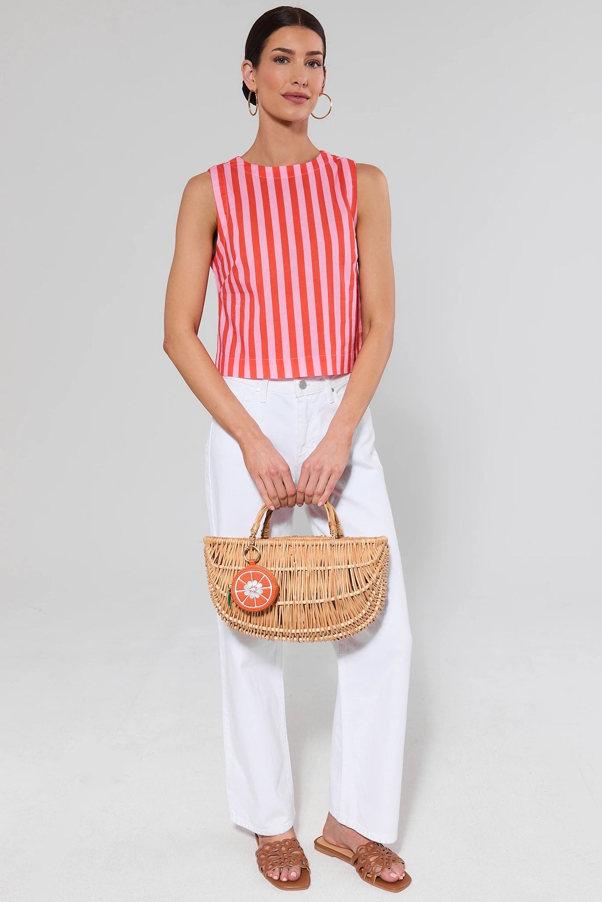 Orange striped Blaire Top styled with white denim and woven rattan bag, full-length look | Avara