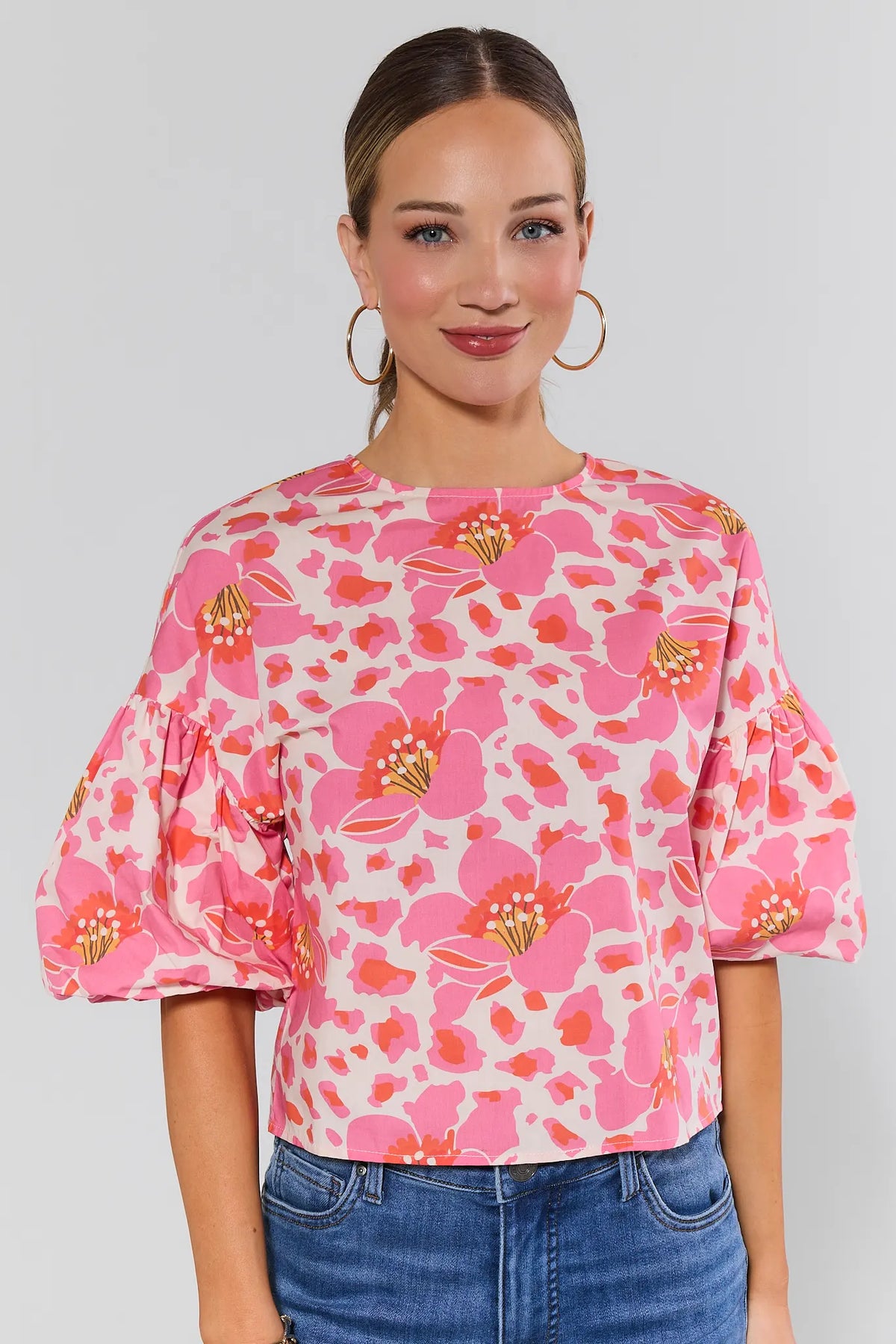 Peyton Pink Floral Print Top with puff sleeves and crew neck, styled with blue jeans - Front View | Avara