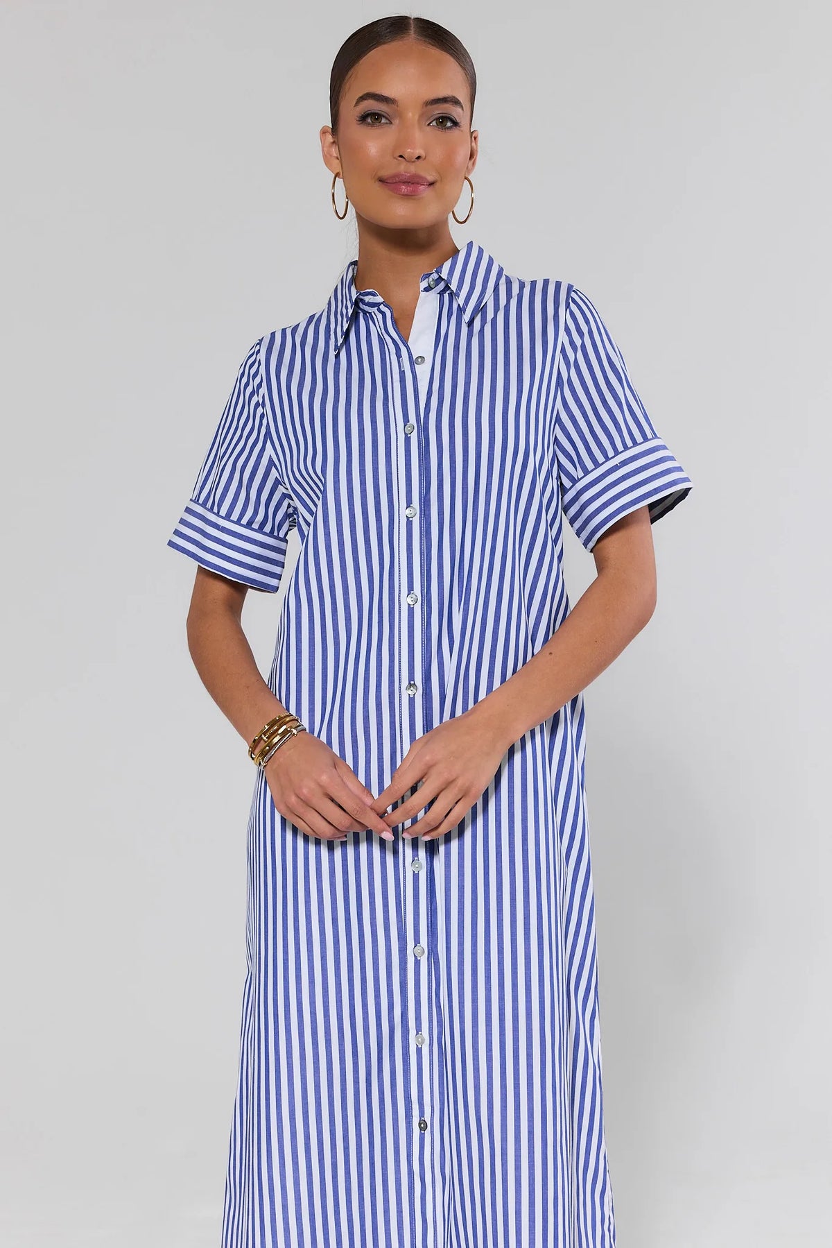 Woman wearing Juniper Blue Striped Midi Dress, button-front shirt dress, front view | Avara