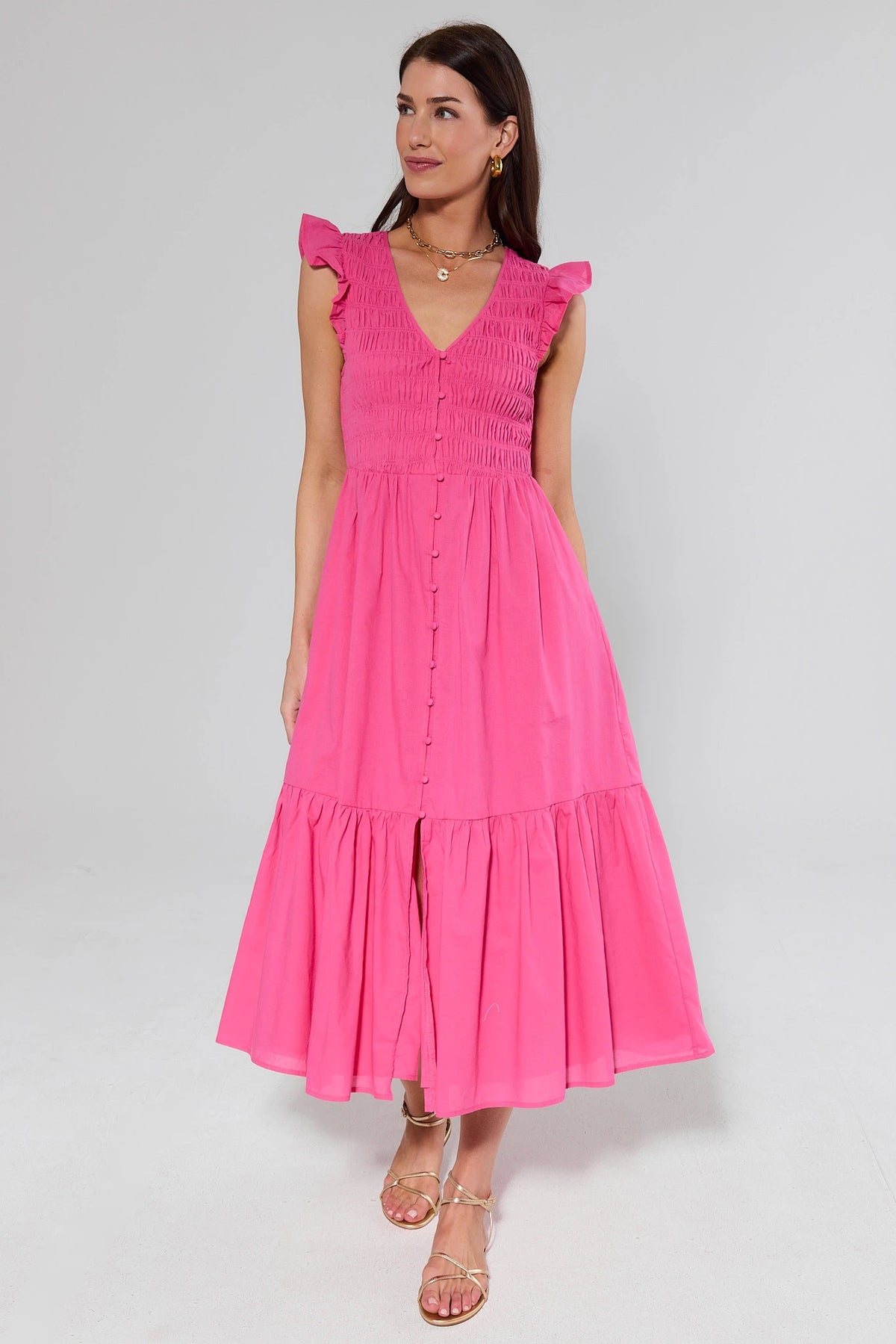 Allyn Pink Smocked Midi Dress full-length front view with gold sandals, tiered skirt detail | Avara