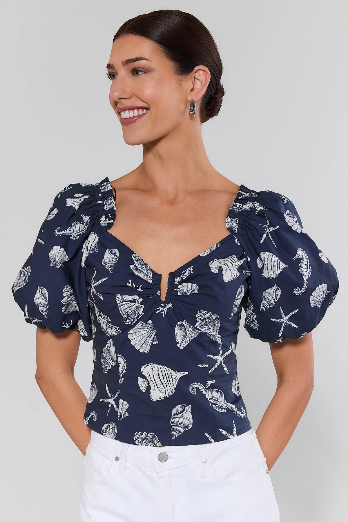 Navy seashell print top with puff sleeves and notched V-neckline - Front View | Avara