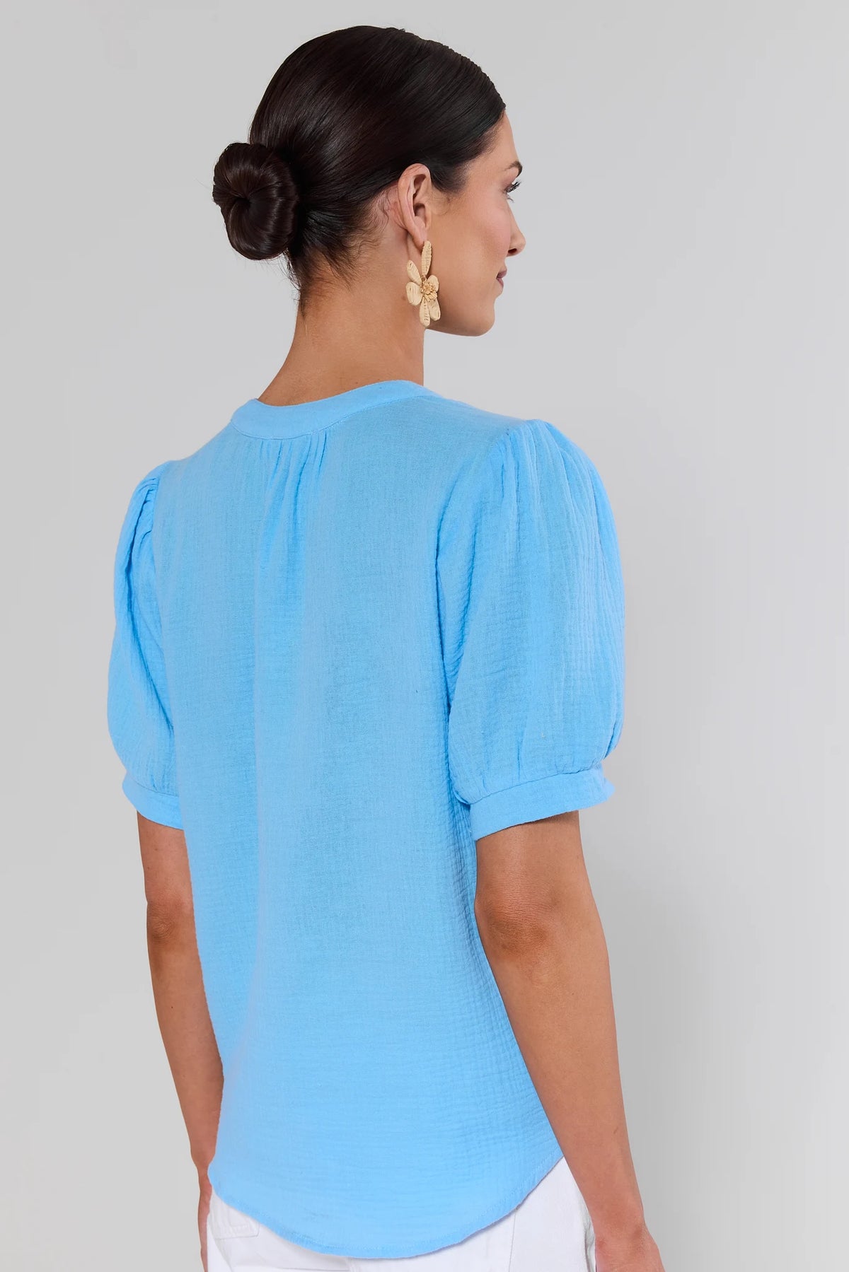 Back view of light blue gauze top with puff sleeves and relaxed fit on model | Avara