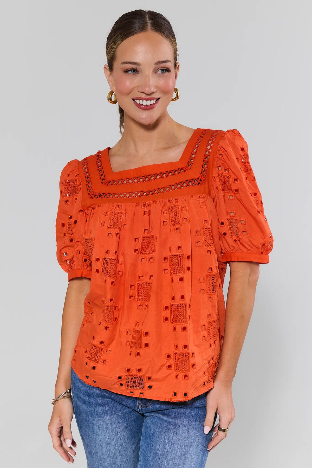 Orange Ines eyelet square neck blouse styled with blue jeans, full-length front view | Avara
