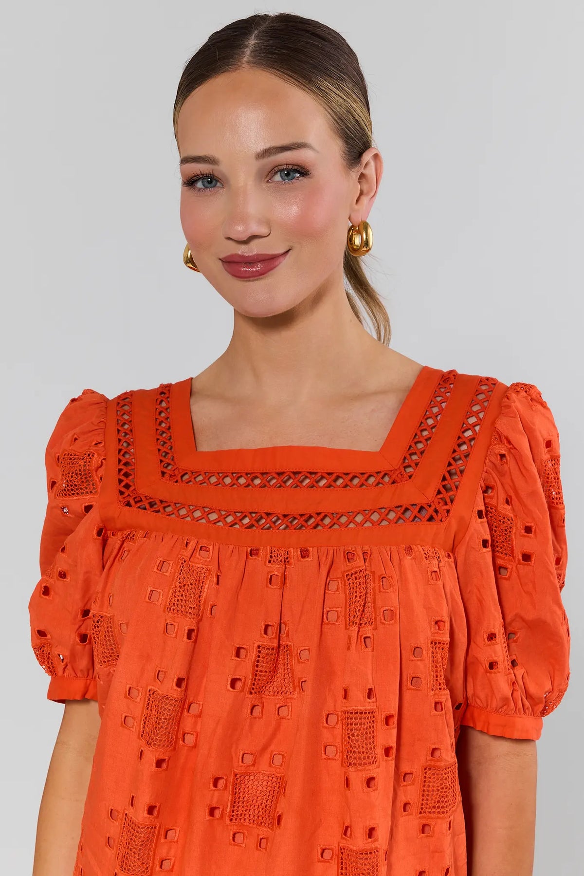 Close-up of orange eyelet top with square neckline and crochet detail, cute top for women | Avara