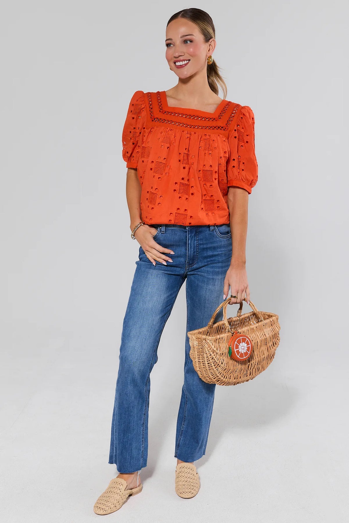 Orange eyelet top with jeans and wicker bag, styled look for weekend outings | Avara