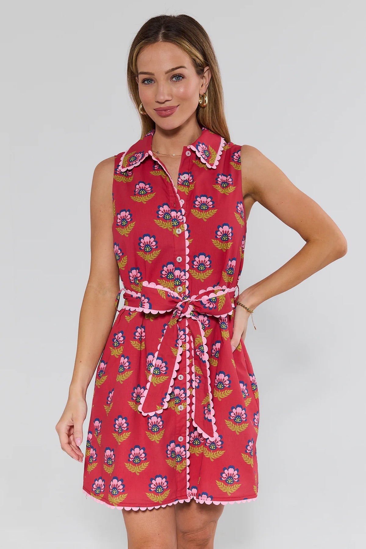 Woman wearing a red floral dress with a white background