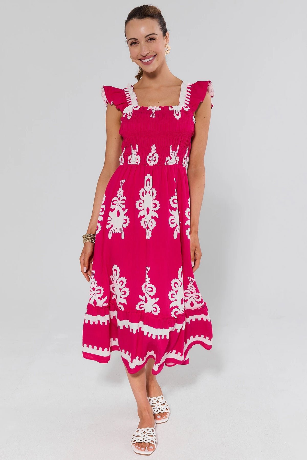 Hot pink abstract print midi dress with smocked bodice and flutter sleeves, front view on model | Avara