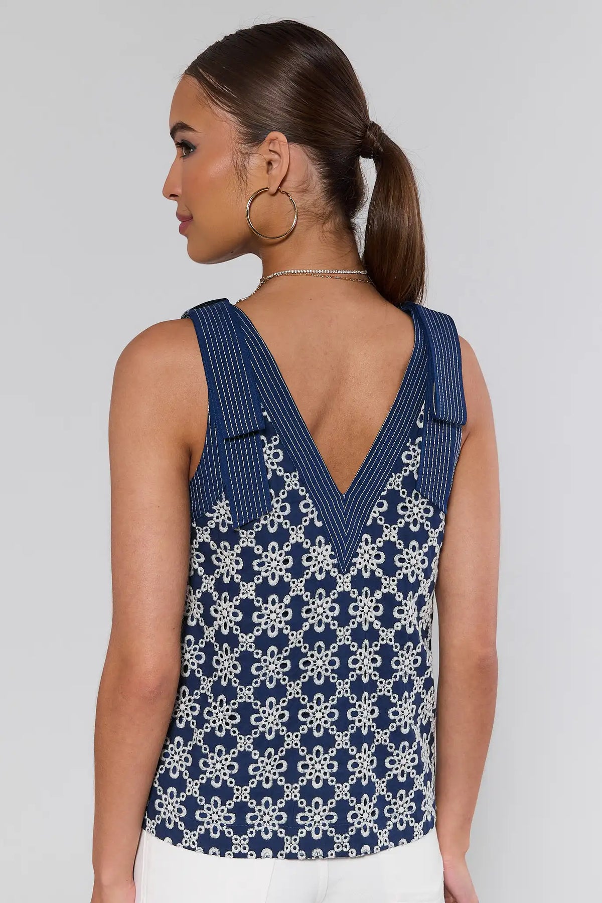 Michelle Navy Embroidered Tank Top side profile view, allover white floral embroidery on navy sleeveless top | Avara