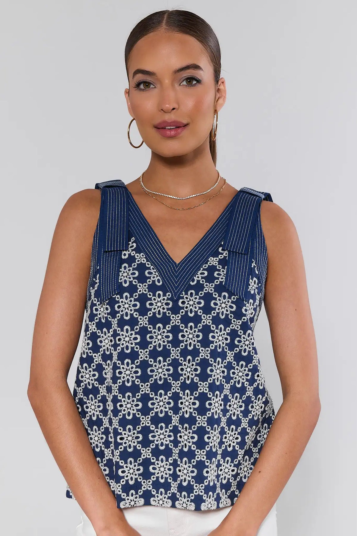 Michelle Navy Embroidered Tank Top front view, women's cute top styled with white wide-leg pants and straw bag | Avara