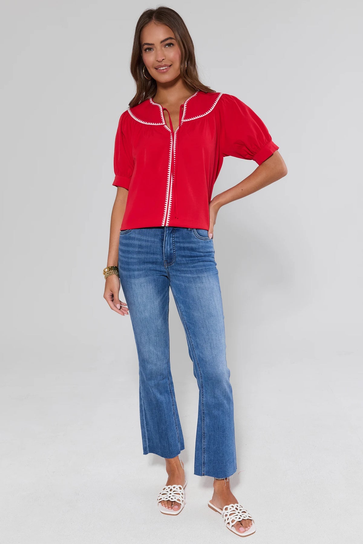 Gabriela Red Stitched Trim Top worn with blue jeans, full-length front view on model | Avara