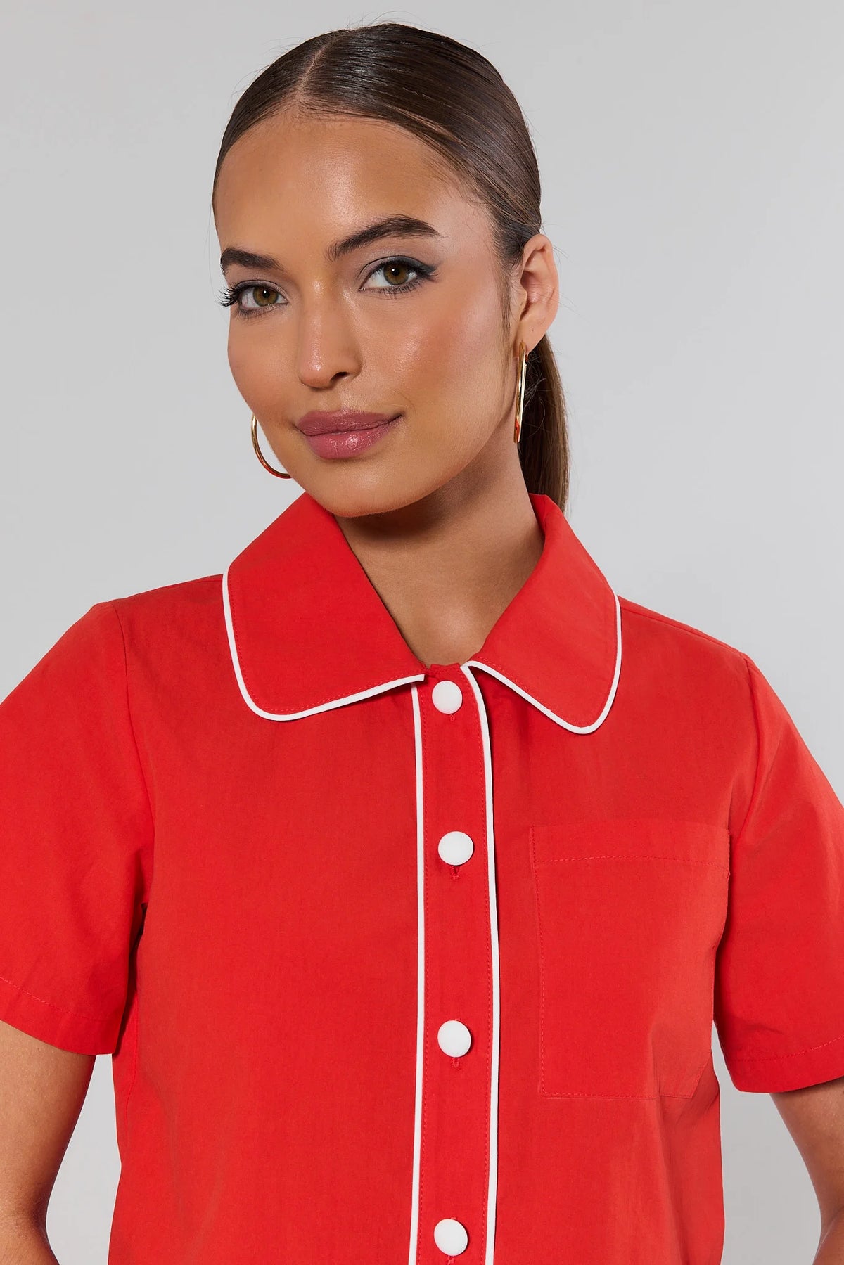 Belle Red Contrast Trim Top close-up showing white piping collar detail and oversized button placket | Avara