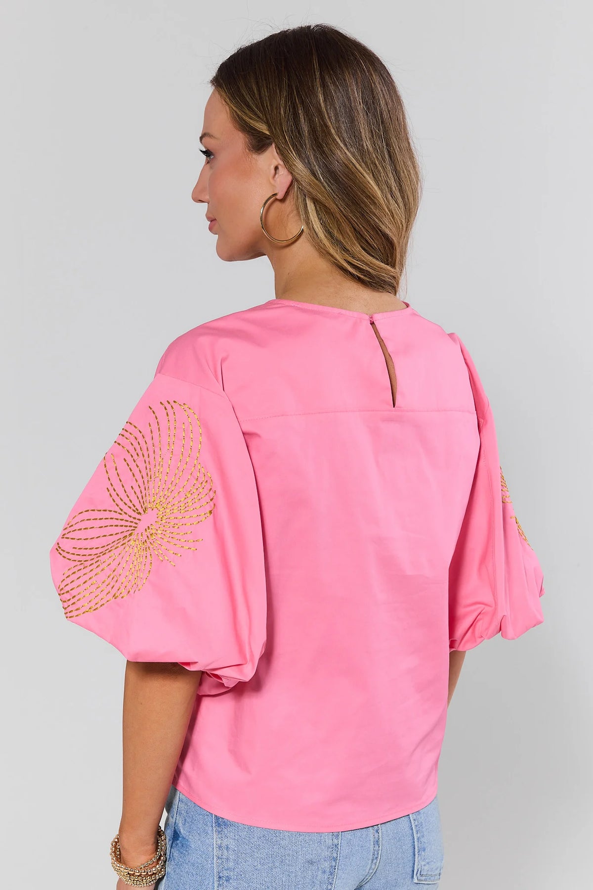 Pink embroidered top with gold floral puff sleeves and keyhole back - Back View On Model | Avara
