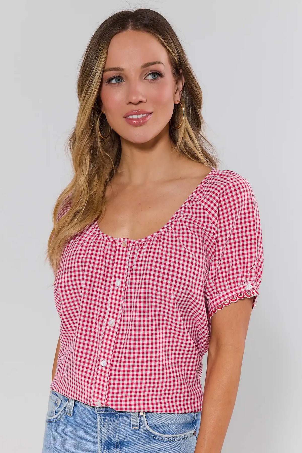 Women's red and white gingham button-up top with scalloped short sleeves and scoop neckline — Three-Quarter Front View | Avara