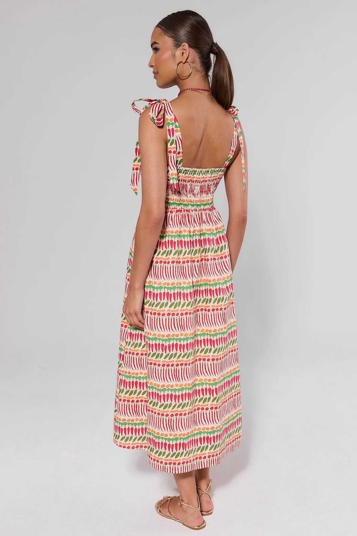 Multi-Printed Smocked Maxi Dress back view showing open back and flowy skirt on model | Avara