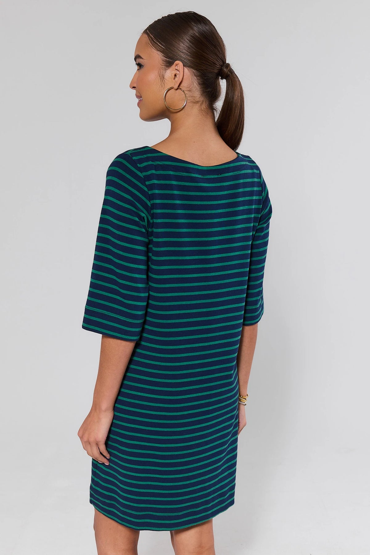 Woman wearing green and navy striped shirt dress showing relaxed silhouette and 3/4 sleeves - Back View | Avara