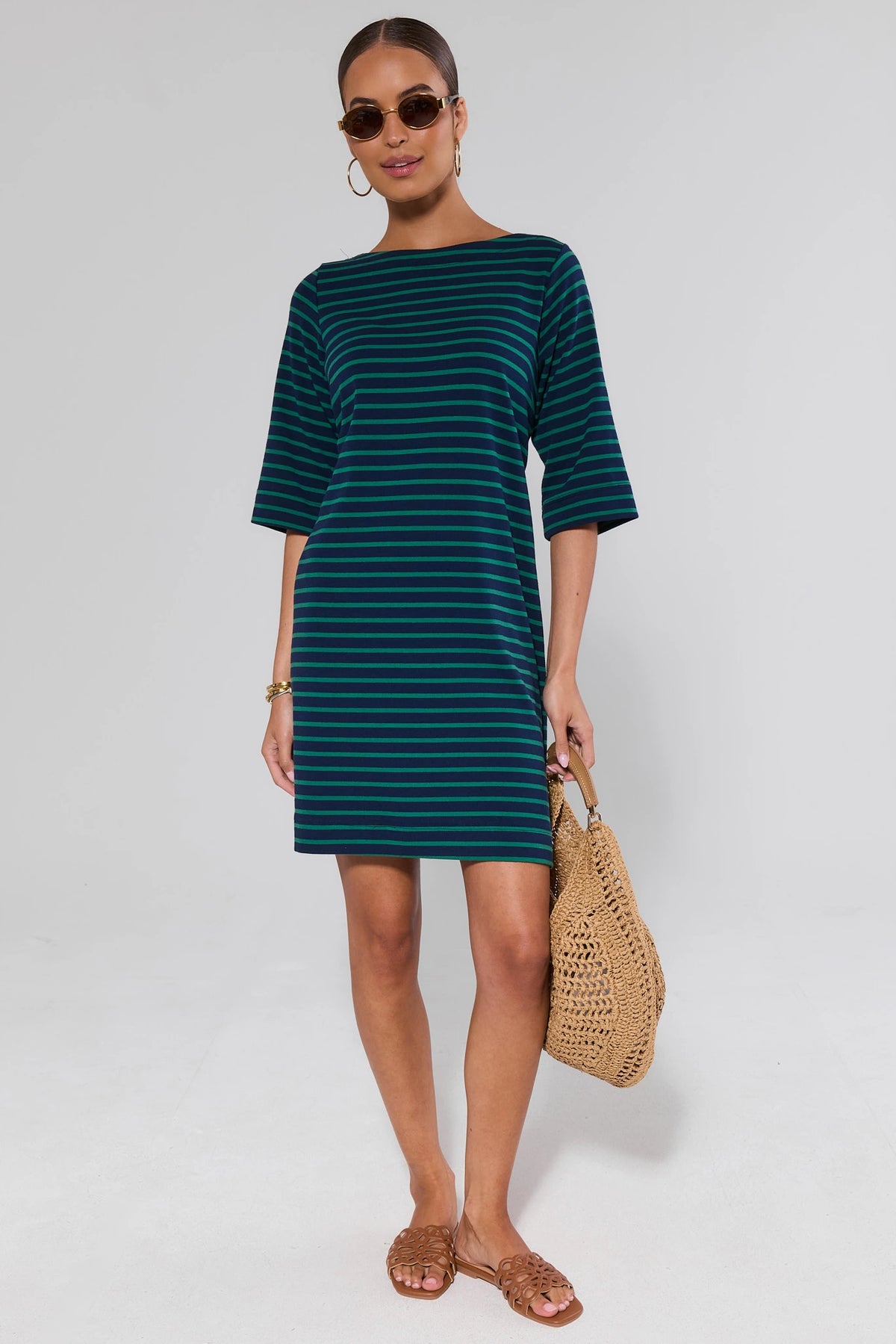 Woman in green and navy striped dress styled with woven bag and sandals - Full Length Styled Look | Avara