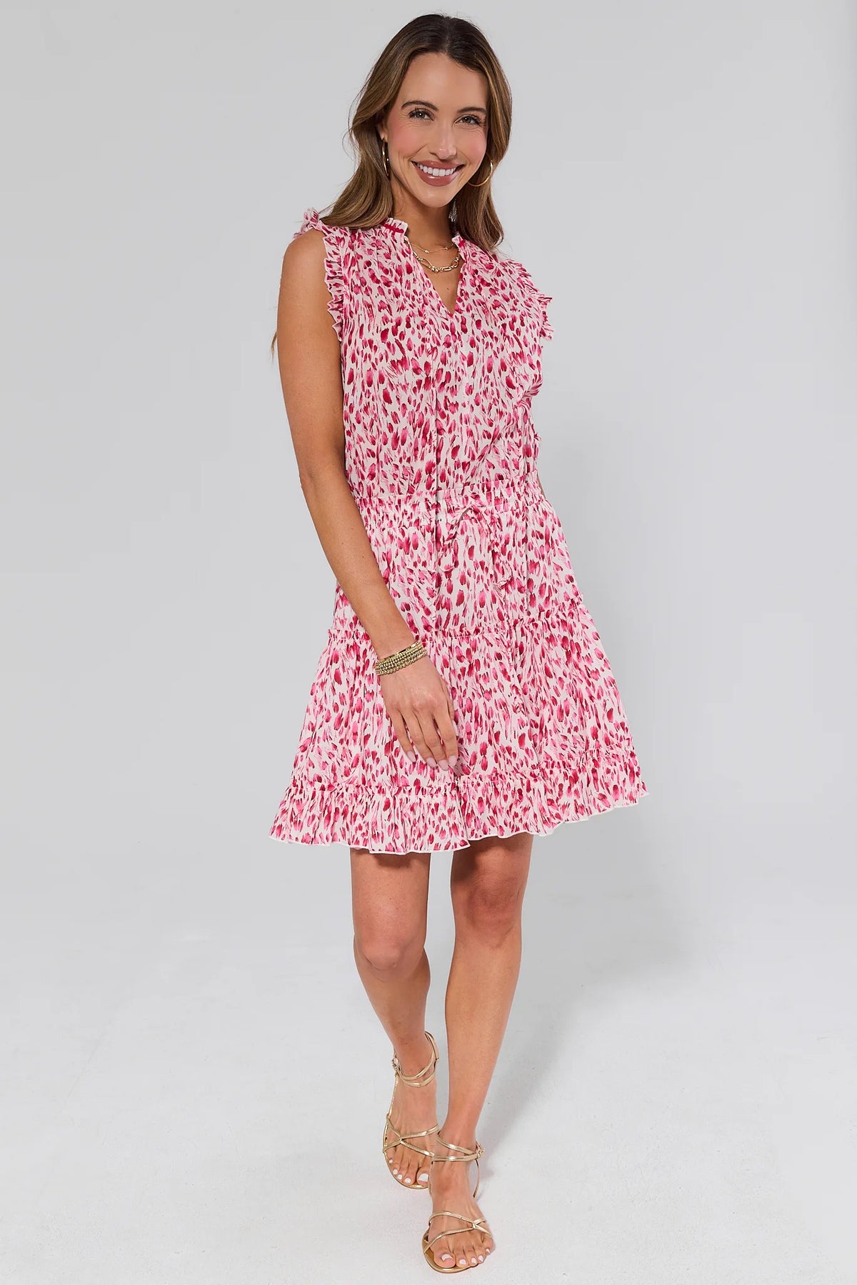Pink printed short dress with tiered ruffled hem styled with gold sandals - Full Length Side View | Avara