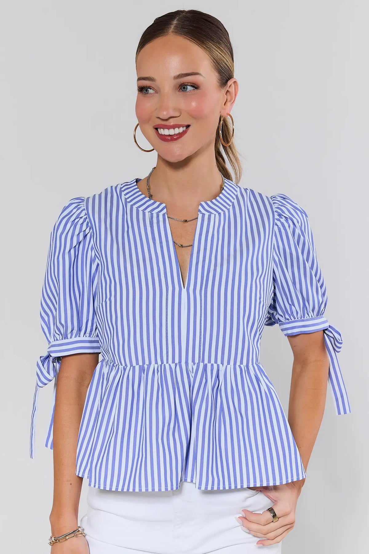 Women's blue striped peplum top with tie sleeves and split neckline - Front View | Avara