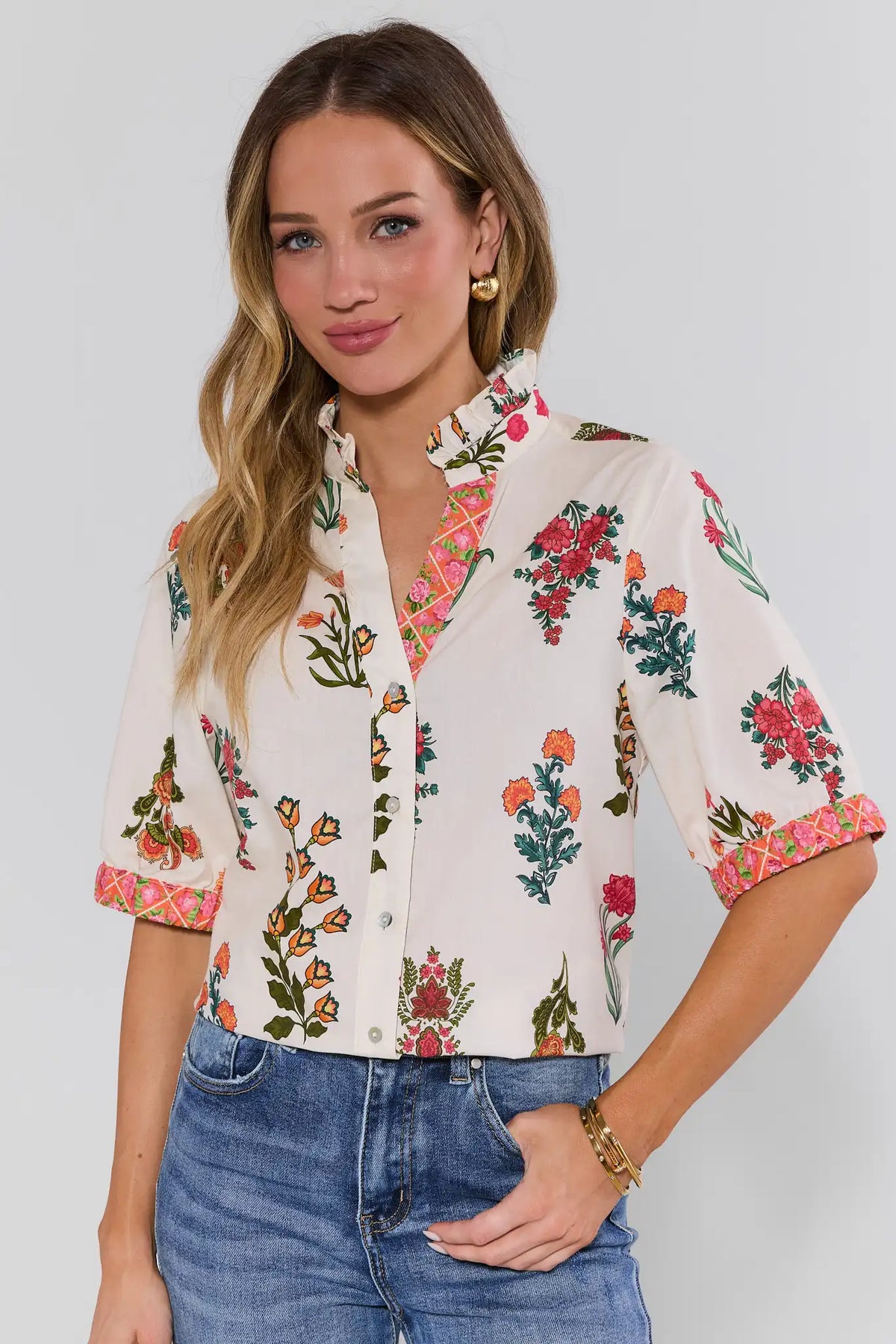 Woman wearing white floral button-up top by THML with pink contrast cuffs, styled with denim - Front View | Avara