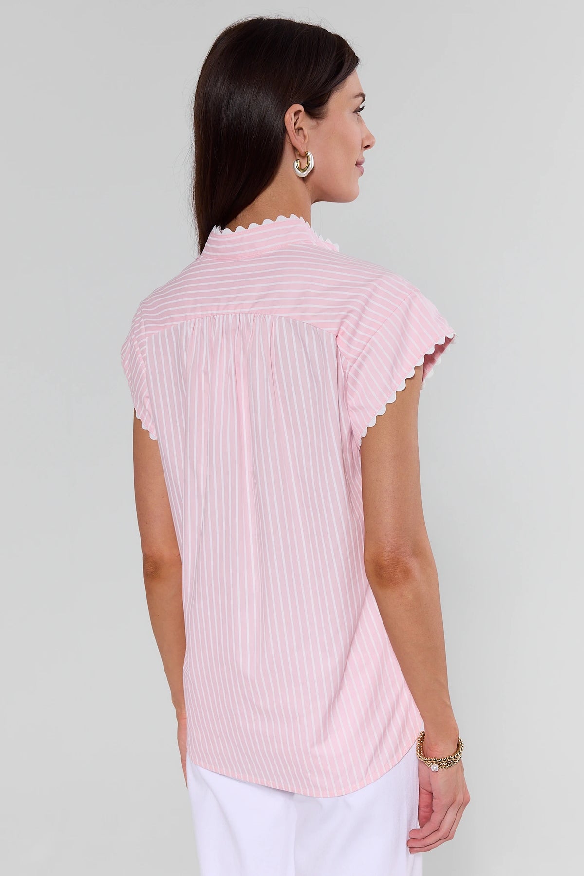 Woman wearing a pink striped shirt against a white background