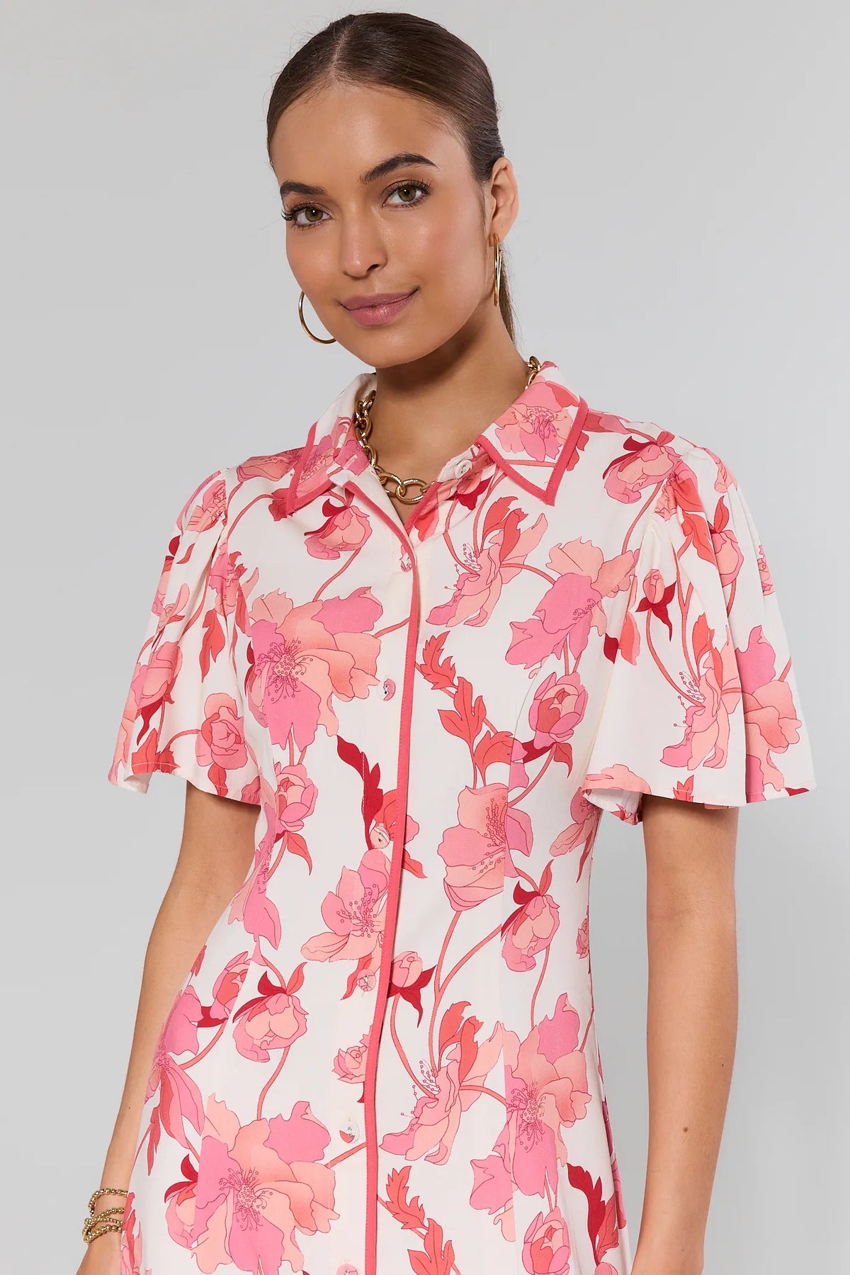 Pink floral button-up midi dress with collared neckline and flutter sleeves - Close-Up Detail | Avara