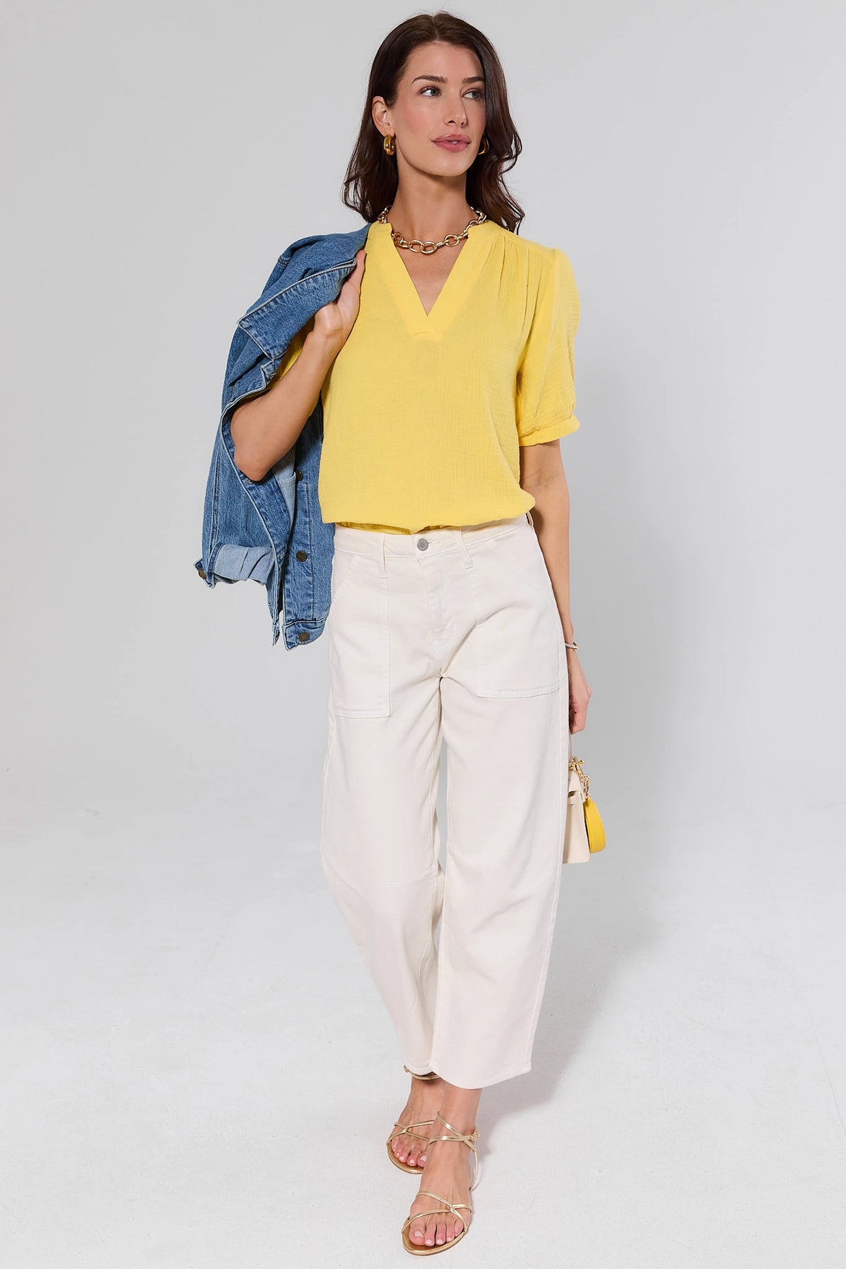 Yellow gauze top styled with white wide-leg pants and denim jacket - full length look | Avara