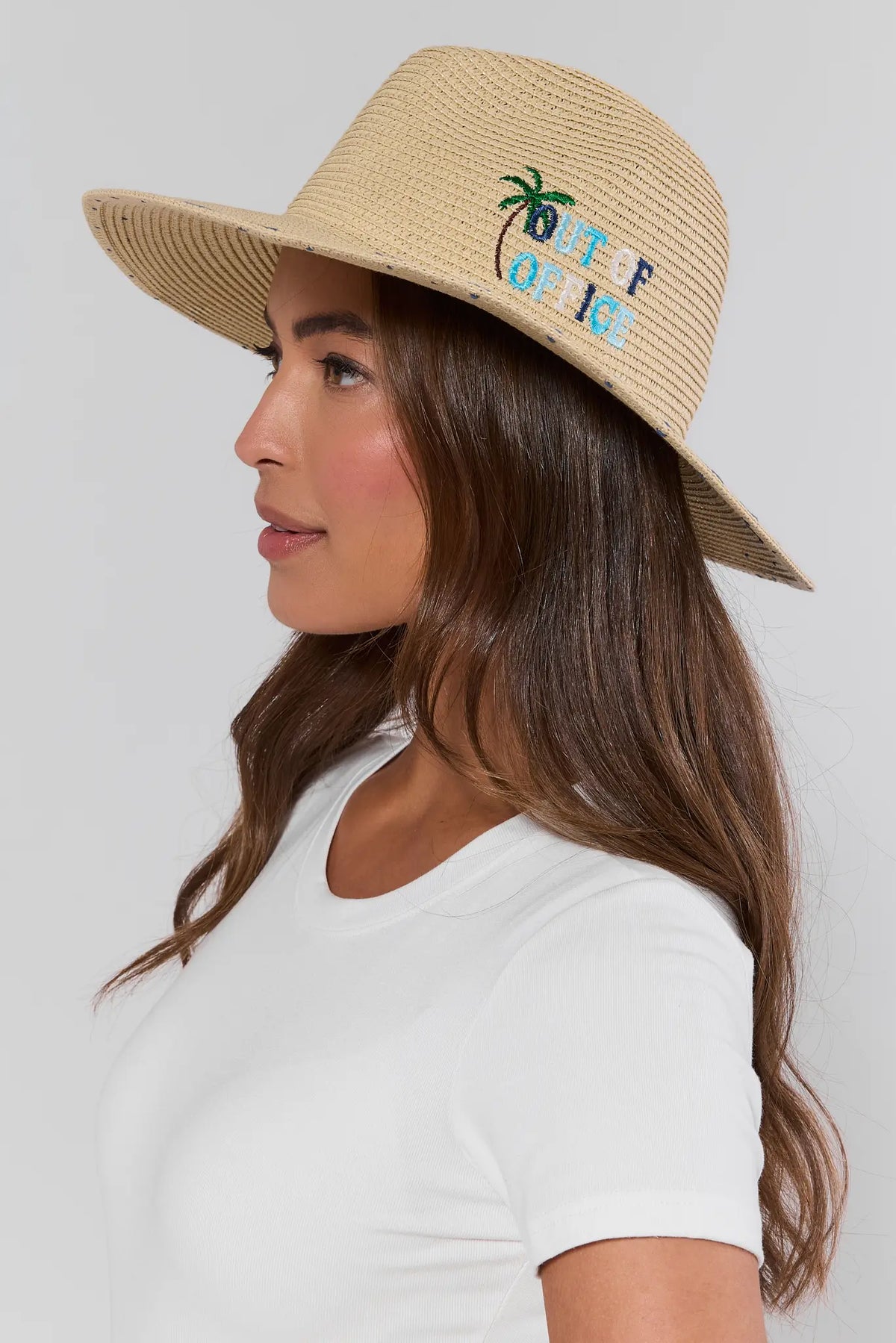 Woman wearing beige embroidered wide brim raffia sun hat with palm tree design - Side Profile On Model | Avara