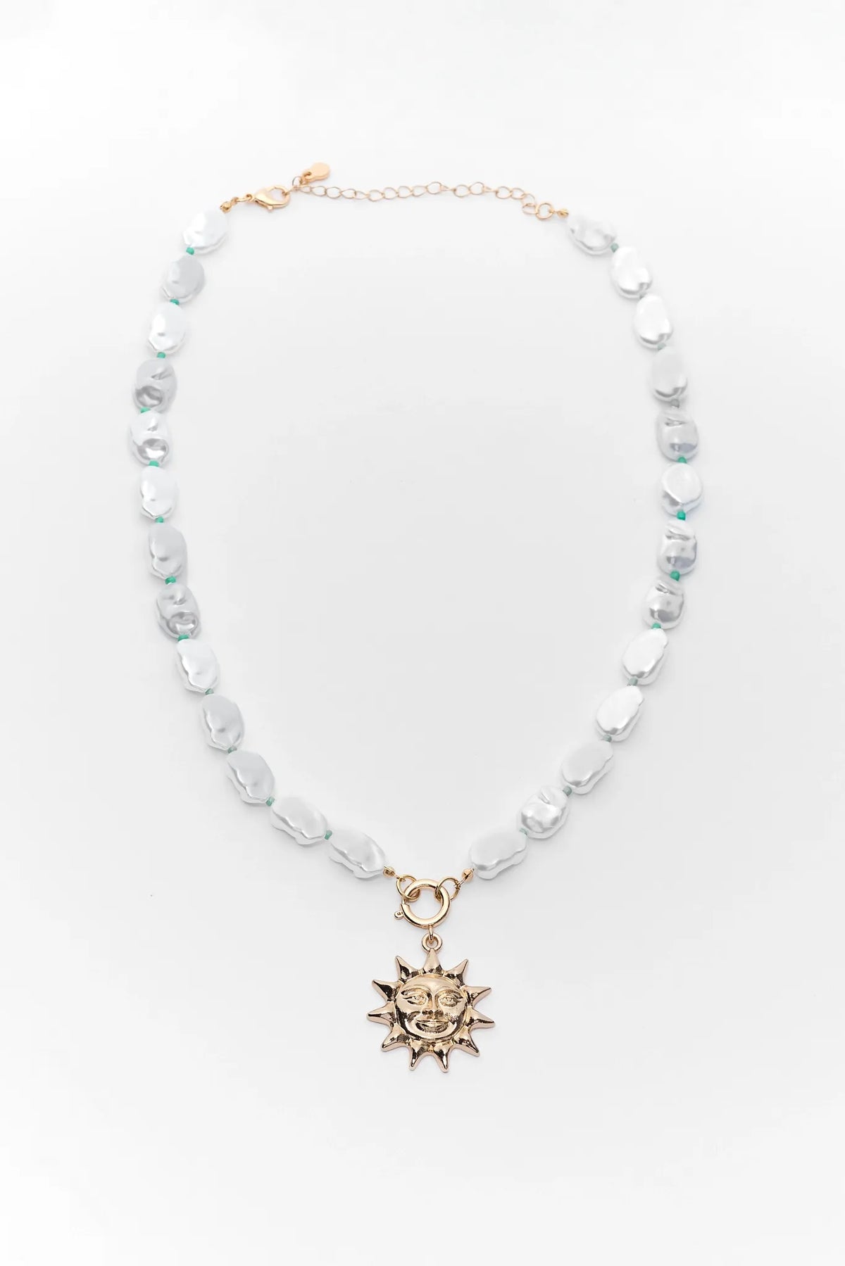 Pearl beaded sun charm necklace with gold-tone sun pendant - Flat Lay | Avara