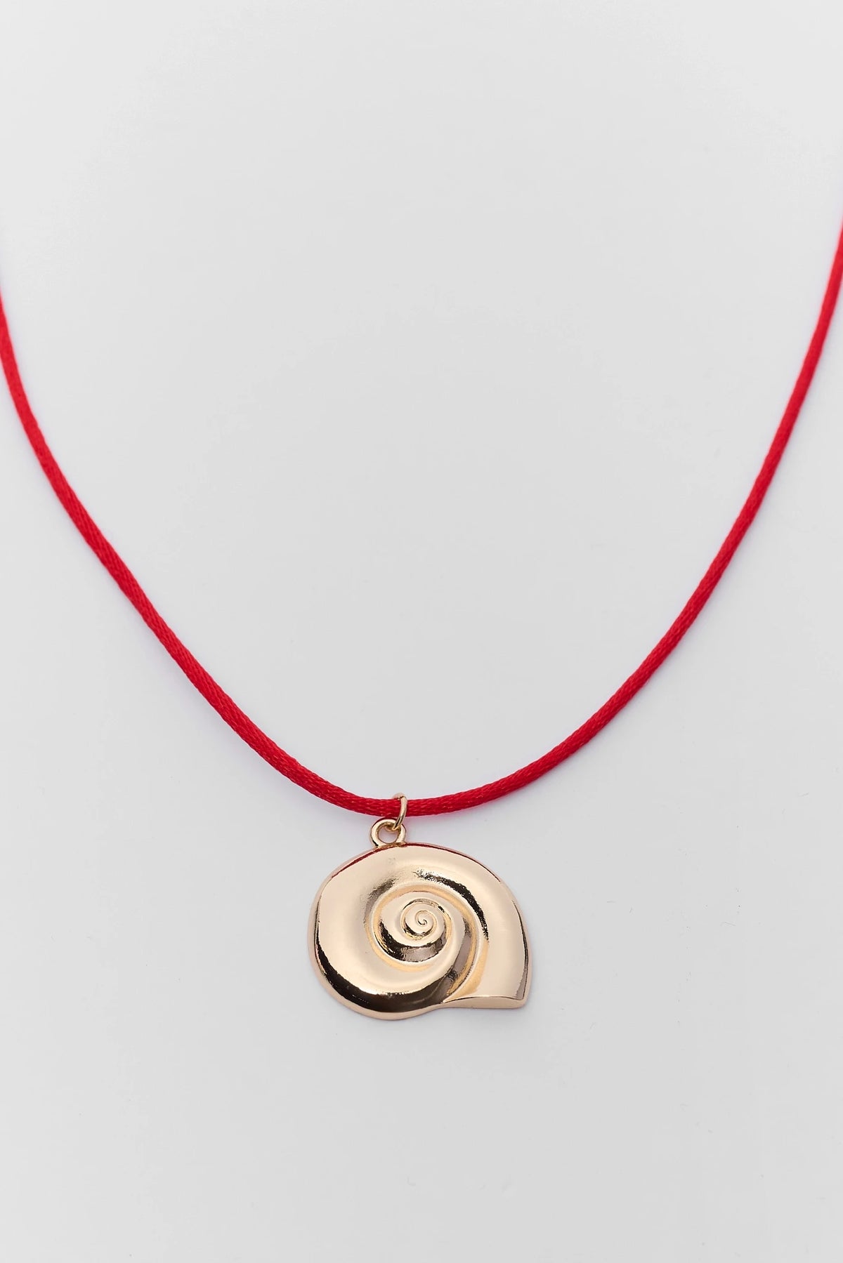 Gold spiral shell charm pendant on red string necklace with gold jump ring - Charm Detail Close-Up | Avara