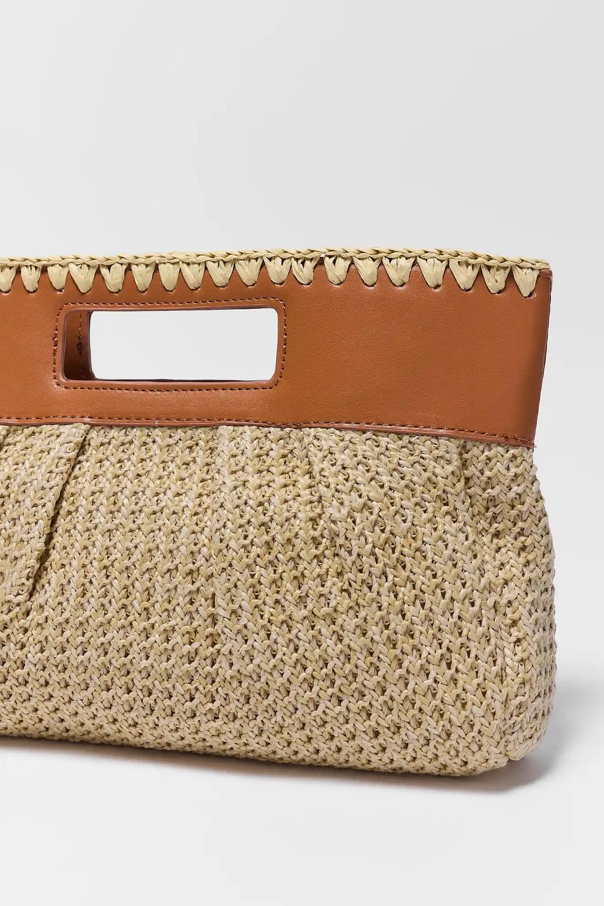 Close-up of tan raffia bag whipstitch trim and faux leather handle detail - Texture Close-Up | Avara